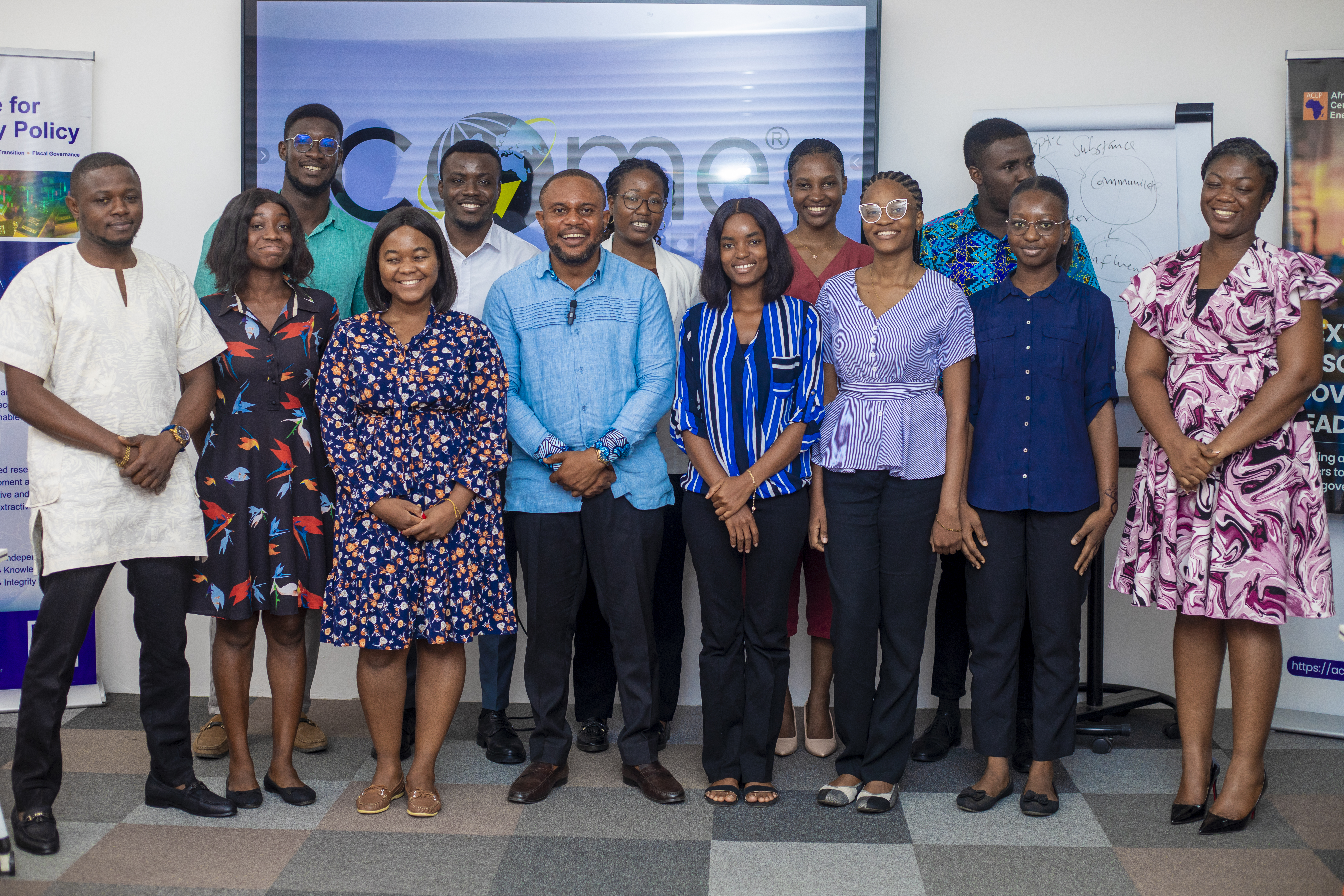 Community and outreach - diverse group gathered outdoors in front of a building, smiling together.